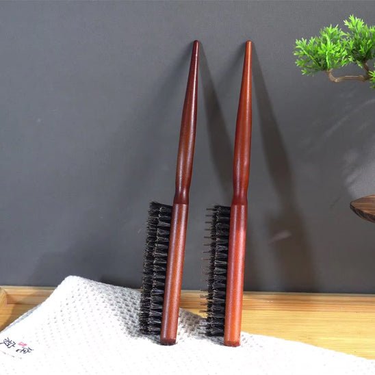 Brosse Poil de Sanglier deux modèles adossées contre un mur gris petit bonzai en décoration