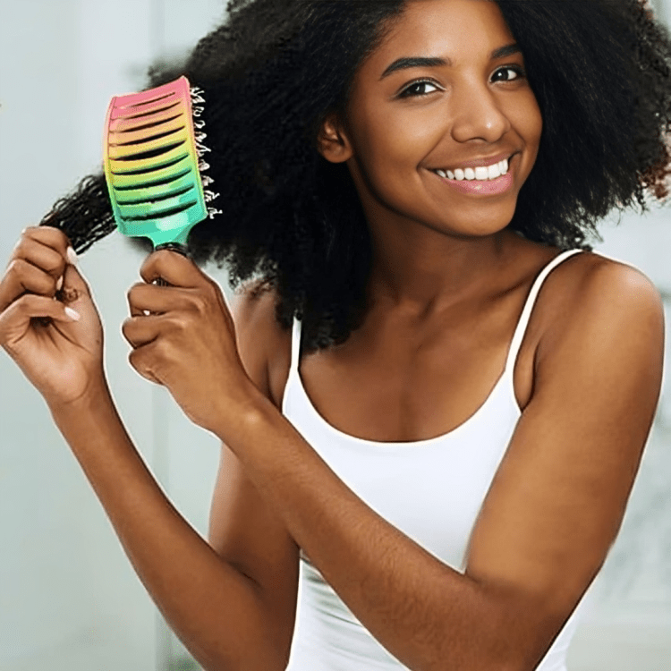jeune femme d'environ 25 ans qui se coiffe les cheveux avec la brosse à cheveux à poils mixtes