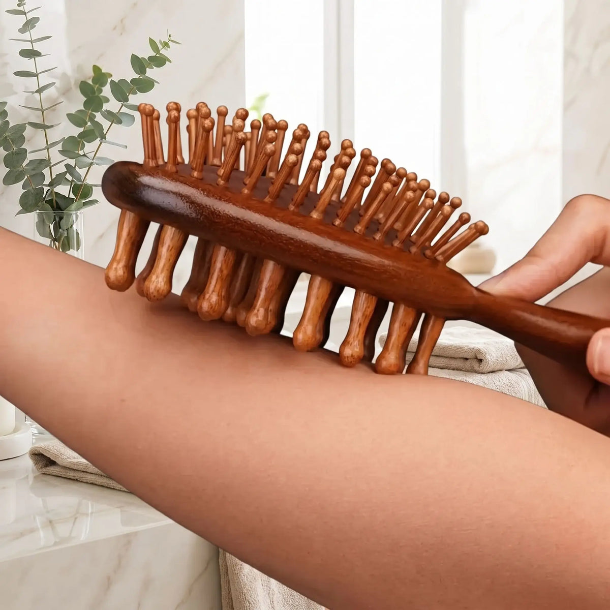 brosse à cheveux en bois de santal qui masse un avant bras