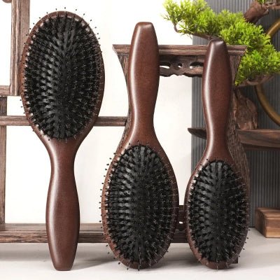 Brosse cheveux Poil de Sanglier - Bois foncé adossées contre une pièce de bois foncée décorative