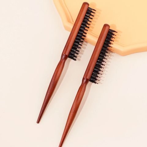 Brosse Poil de Sanglier deux modèles offerts posées sur un plat jaune