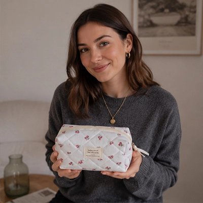 Trousse de toilette une jeune femme montre la trousse afin d'en apprécier les caractéristiques