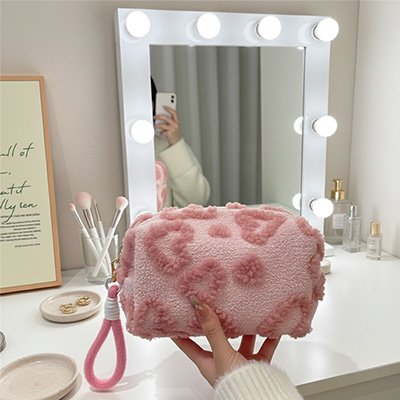 Trousse de toilette une main qui tient la trousse afin d'en apprécier les caractéristiques